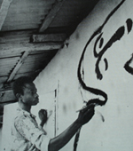 Jacob Afolabi painting one of his murals